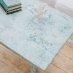 Saltwash painted coastal coffee table in blue tones close up on texture