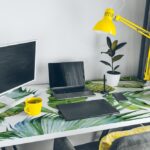 Workplace. white desk with laptop and yellow cup. designer worki